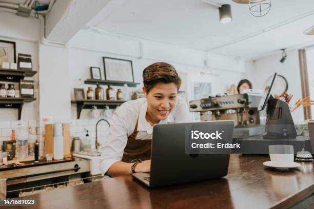 Owner Of Coffee Shop Ordering Product For Her Shop From Online Store Stock Photo - Download Image Now