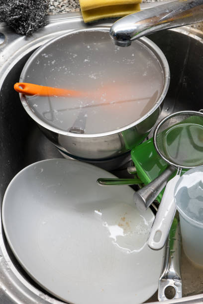 a pile of dirty dishes and utensils in a kitchen sink. top view, no people. - sink domestic kitchen kitchen sink faucet imagens e fotografias de stock