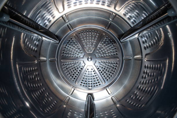 istock Washing machine or tumble drier metal perforated empty drum. Inside wide-angle view, no people. 1471689497
