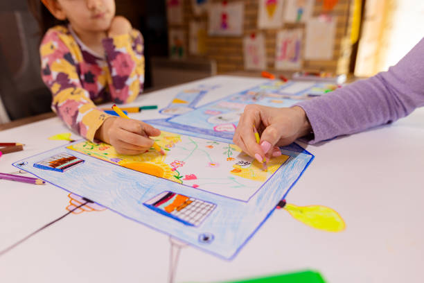 Little girl and her mom use their artistic skills to create a stunning robot drawing for class.