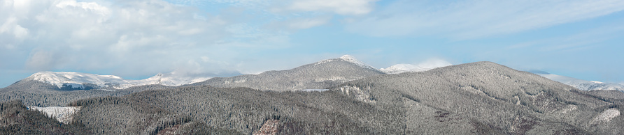 Picturesque winter morning mountains panorama view from Skupova mountain alpine slope. Verkhovyna district, Ukraine, view to Chornohora ridge and Pip Ivan mountain top, Carpathian.