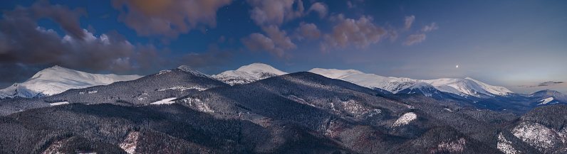 Picturesque winter night mountain view from Skupova mountain slope, Ukraine, view to Chornohora ridge and Pip Ivan mountain top with observatory building, Carpathian.