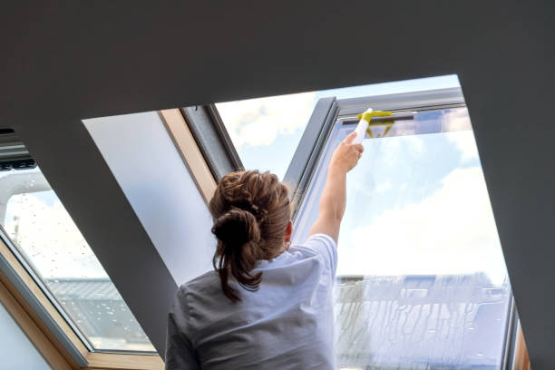 istock Woman cleaning window skylights at home. 1471695695