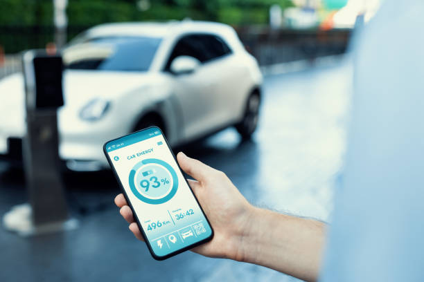 istock Closeup progressive idea hand holding smart phone display EV's batter status. 1471696173