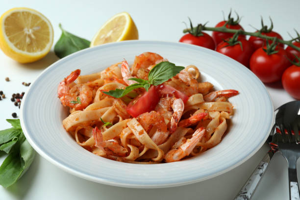 istock Plate of shrimp pasta and ingredients on white background 1471697079