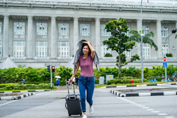 istock Running In The Rain with luggage 1471697814