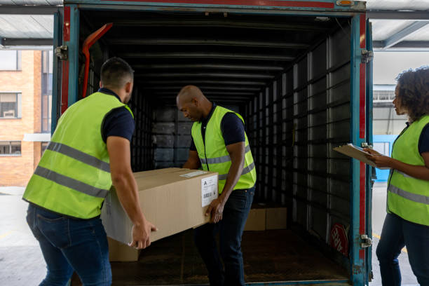 istock Group of workers loading boxes on a truck at a distribution warehouse 1471700303