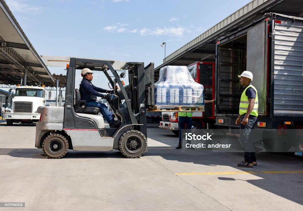 Workers At A Distribution Warehouse Loading Merchandise On A Truck ...