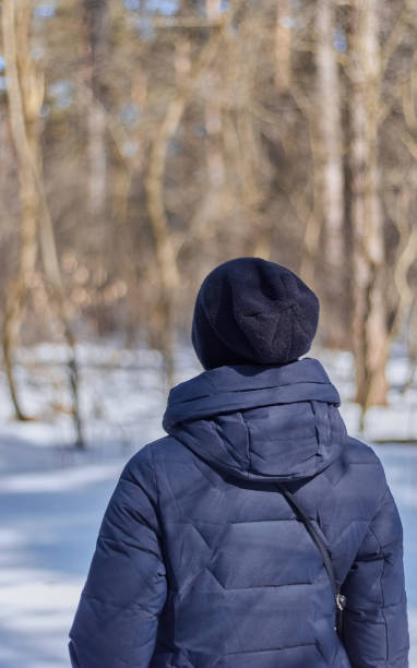 istock Girl in a blue down jacket winter view from the back 1471701949