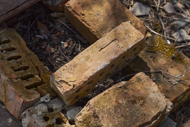 randomly stacked brown old brick. - color image solid brown bumpy imagens e fotografias de stock