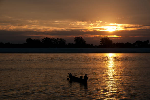 istock Sunset with fishing boat on Irrawaddy River 1471702448