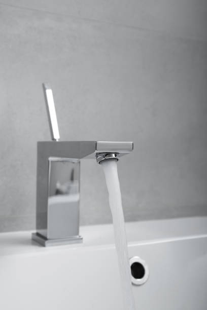 istock Water pouring from a faucet 1471703109