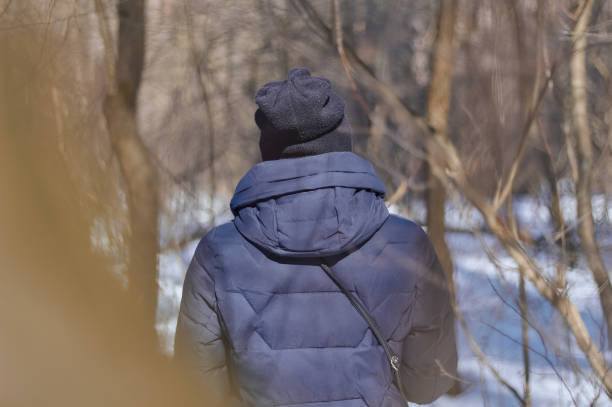 istock Girl in a blue jacket winter view from the back. 1471703112