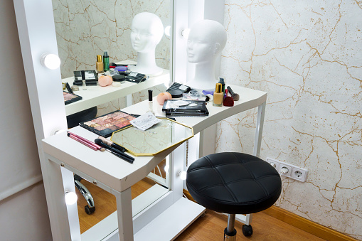 Room with a table and mirror with make up tools in a backstage