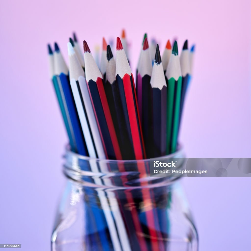 Creativity, art and drawing pencil container for school coloring stationery zoom. Closeup of a glass jar with color pencils in purple gradient studio background for creative education. Closeup of many pencils in a glass jar isolated on a colorful background. Macro view of stationery for art and drawing. School supplies for a student or artist. Education and creative still life Arrangement Stock Photo