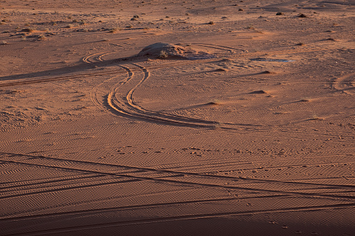Tires tracks in the Wadi Rum desert. The Wadi Rum is at the edge of the Arabian desert and is famous for it's gargantuan rock formations, rippled sand dunes, and it's link to the English adventurer, T.E. Lawrence, the original \