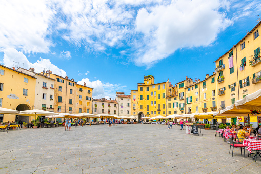 The ancient amphitheater, now a gathering place for Italians and tourists with cafes and shops, the Piazza del Anfiteatro, in the Tuscan walled town of Lucca, Italy.