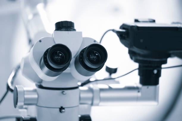 istock microscope with built-in camera, Two eyepieces of a large microscope, Professional biocular laboratory microscope with stereo eyepiece. Modern dental clinic with microscope tool for treatment patients. 1471713438