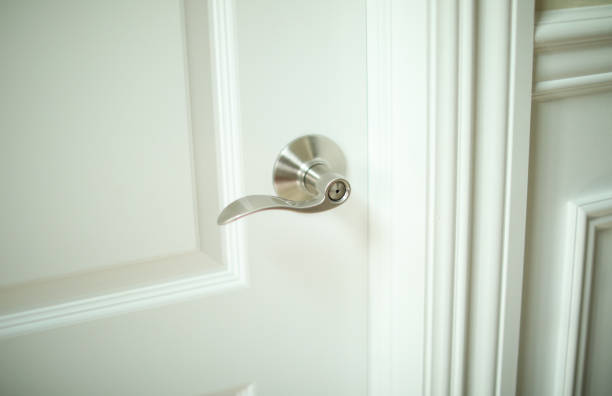 istock Metallic door handle in modern door also showing keyhole symbolizing security at home and office 1471715909