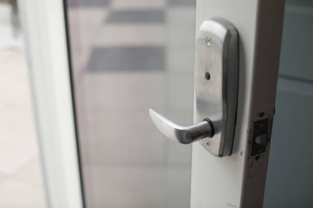 istock Metallic door handle in modern door also showing keyhole symbolizing security at home and office 1471715913