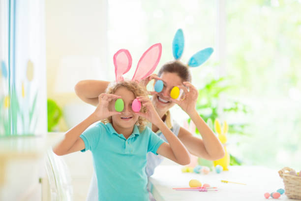 istock Mother and kids, family coloring Easter eggs. 1471719553