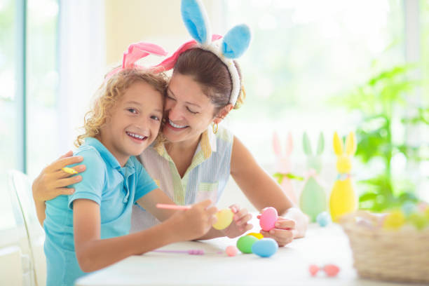 istock Mother and kids, family coloring Easter eggs. 1471719764