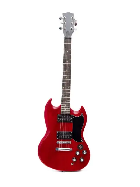 Photo of Red electric guitar isolated on white background. Musical instrument guitar.