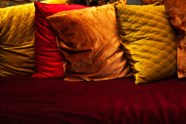 interior moderno da sala de estar com sofá de veludo cinza e travesseiros coloridos em casa - pillow cushion red textile - fotografias e filmes do acervo