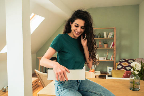 istock Young woman opening a package from the courier service 1471724008
