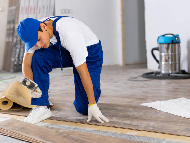 istock Young carpenter using rubber mallet to lay laminate flooring indoors 1471724292