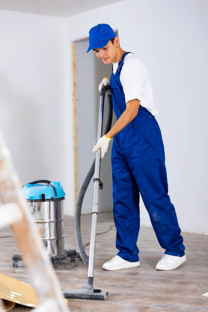 istock Young contractor using vacuum cleaner after repair work indoors 1471724318
