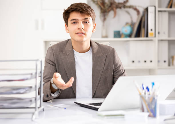 istock Businessman offerring hand for greeting in office interior 1471724364