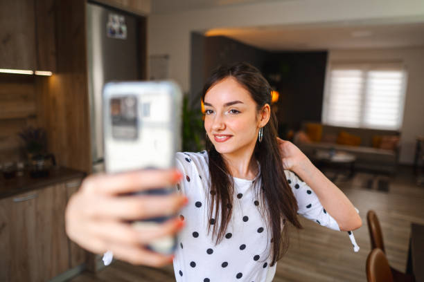 istock Lovely young woman taking selfies while standing in good natural lightning 1471725975