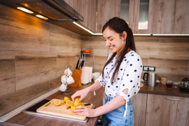 istock Lovely young woman making fresh lemonade in the kitchen 1471726217