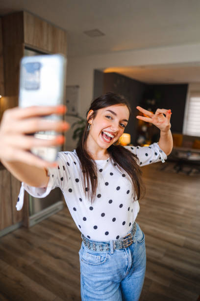 istock Smiling young woman taking selfies while standing in good natural lightning 1471726234