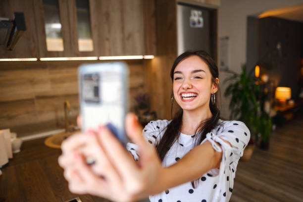 istock Smiling young woman taking selfies while standing in good natural lightning 1471726244