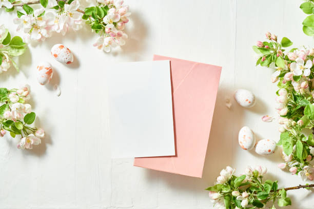 istock Mockup invitation or blank greeting card and envelope with spring flowers. Easter eggs on a light background 1471726266