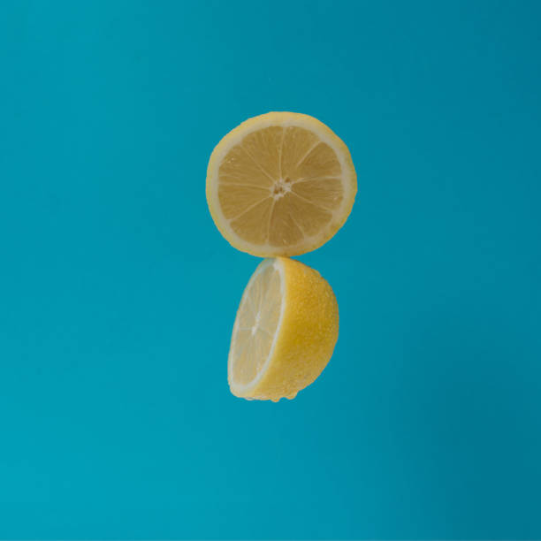 istock Two halves of  fresh lemon against pastel blue background 1471726644