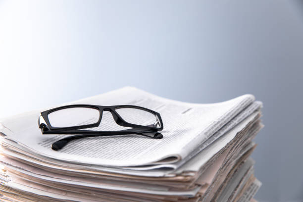 istock Pile of newspapers and optical glasses 1471726675