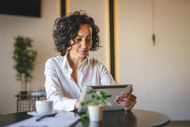 istock One woman mature female entrepreneur use digital tablet for work 1471727326
