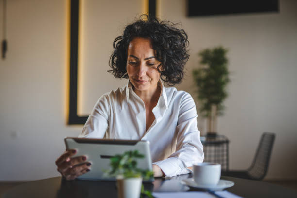 istock One woman mature female entrepreneur use digital tablet for work 1471727452