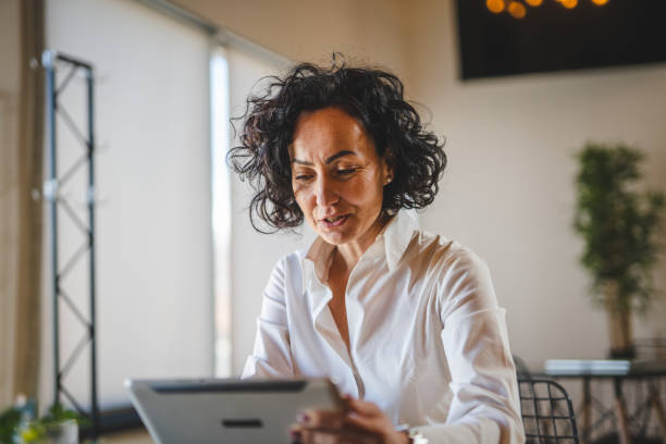 istock One woman mature female entrepreneur use digital tablet for work 1471727454