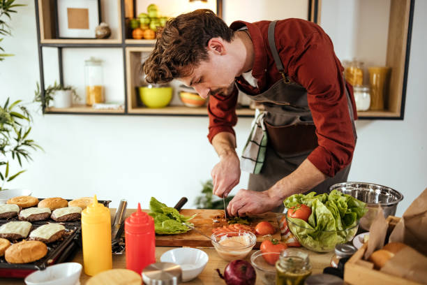 istock Male chef is chopping cucumbers 1471727498