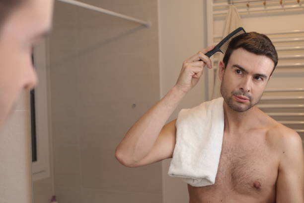 istock Handsome man combing his hair 1471727658