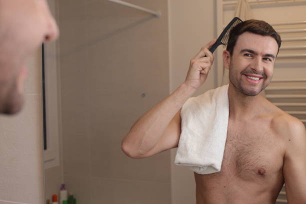 istock Handsome man combing his hair 1471728489