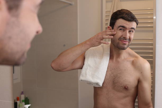 istock Man observing his image in the mirror 1471730128