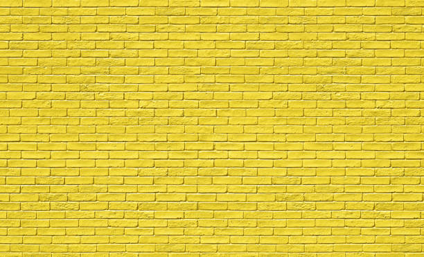 istock yellow brick wall in spring. Stones for a modern concept background with copy space 1471732556