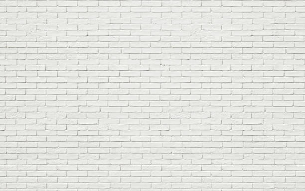 parede de tijolos brancos, fundo iluminado pelo sol. textura de pedra pintada clara para modelos de design ou pano de fundo da web - brick wall paving stone brick wall - fotografias e filmes do acervo