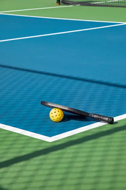 Photo of Pickleball Court with Paddle and Ball