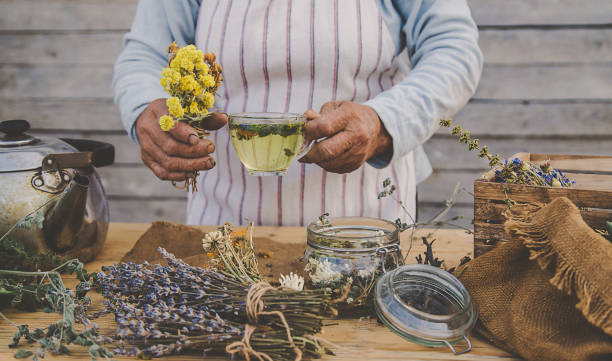 istock Grandmother makes tea with medicinal herbs. Selective focus. 1471735412
